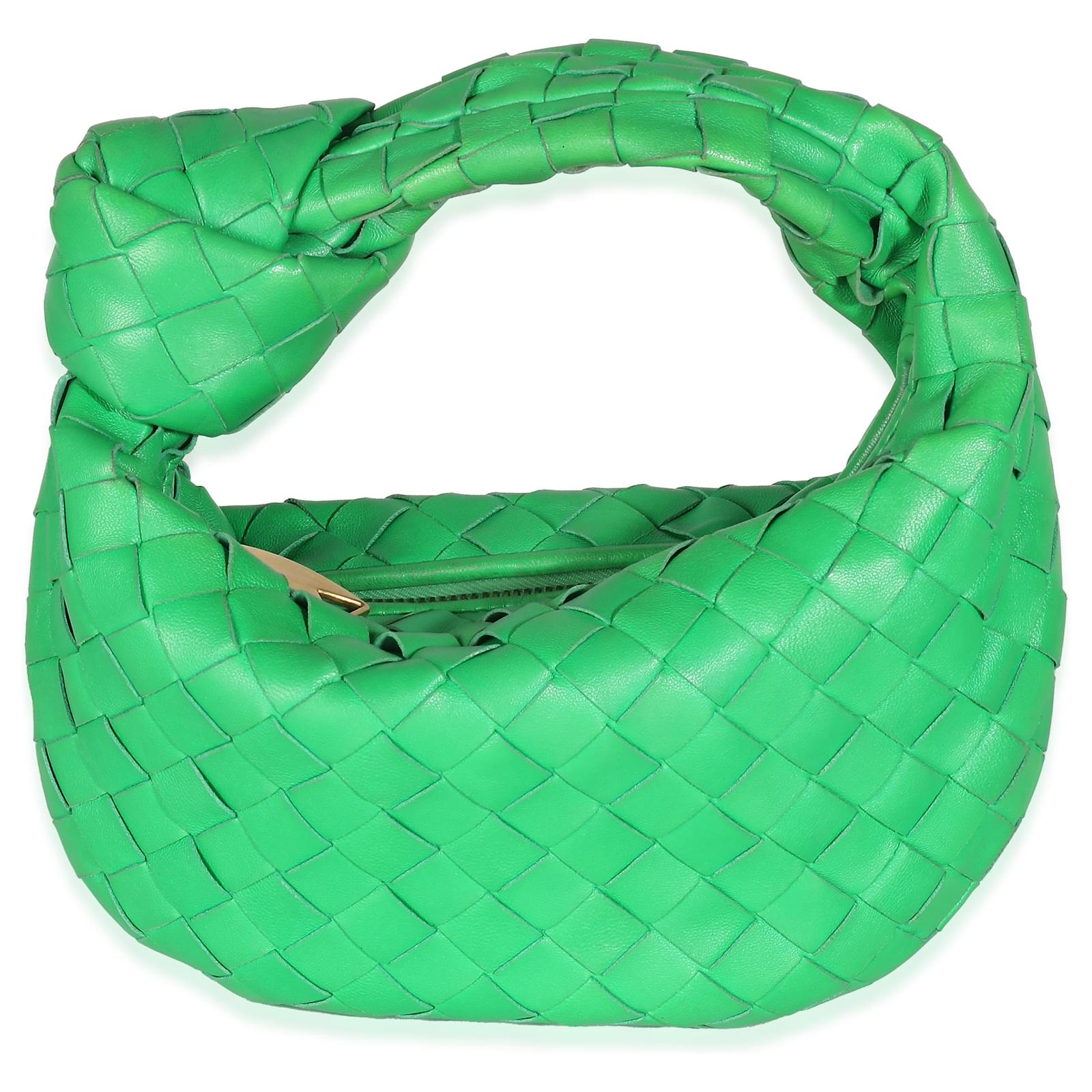 Green woven bag with a knotted handle; exact size and variant unverified